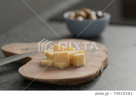 Pieces of hard vintage cheese on wood olive board 74010381