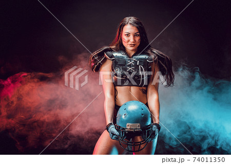 Young brunette wearing sexy uniform of rugby football player posing 74011350