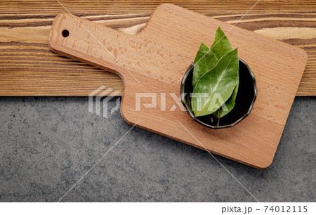The bay leaves in ceramic bowl on shabby wooden background with copy space . The bay leaves in ceramic bowl on shabby wooden background with copy space . 74012115