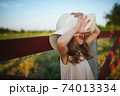 little girl in linen dress in countryside 74013334