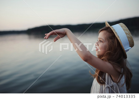 little cute girl with long hair on the lake little cute girl with long hair on the lake 74013335