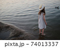 little cute girl with long hair on the lake 74013337