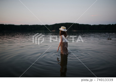 little cute girl with long hair on the lake little cute girl with long hair on the lake 74013339