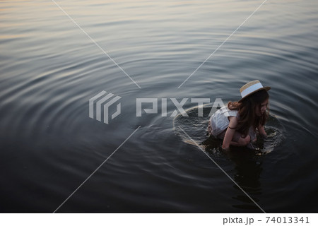 little cute girl with long hair on the lake little cute girl with long hair on the lake 74013341