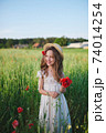 cute little girl in meadow with red poppies 74014254