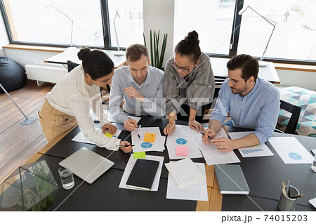 Diverse team of professionals analyzing marketing research Diverse team of professionals analyzing marketing research 74015203