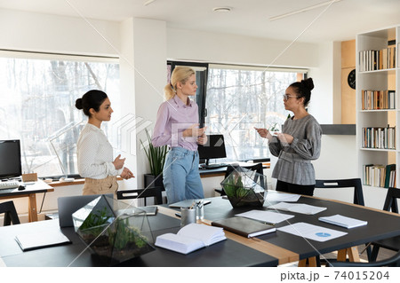 Mixed raced team of managers discussing work issues in meeting room Mixed raced team of managers discussing work issues in meeting room 74015204