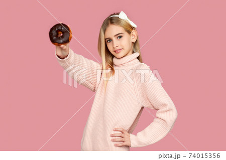 cchild girl holding yummy chocolate donut 74015356