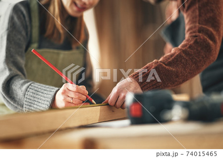 Artisan coworkers creating woodwork in workshop Artisan coworkers creating woodwork in workshop 74015465