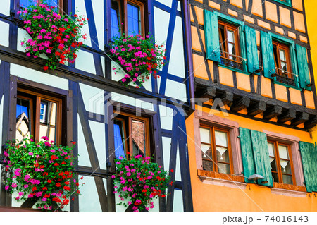 Traditional architecture of Alsace - half timbred colourful houses, Riquewihr village, France Traditional architecture of Alsace - half timbred colourful houses, Riquewihr village, France 74016143