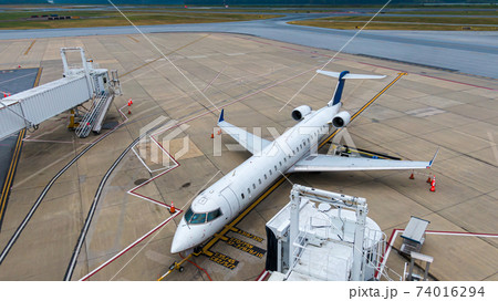 Aerial view of regional airport with terminal and airplanes Aerial view of regional airport with terminal and airplanes 74016294