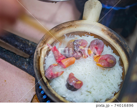 Close up shot of cooking the traditional eel fish claypot rice Close up shot of cooking the traditional eel fish claypot rice 74016896