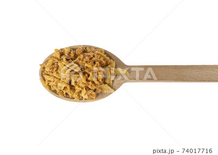 Crispy carmelized fried onion flakes in wooden spoon isolated on white background. Spices and food ingredients. Crispy carmelized fried onion flakes in wooden spoon isolated on white background. Spices and food ingredients. 74017716