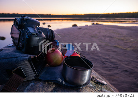 Photographer's bag with 2 apples and coffee. 74020723