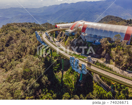 Famous tourist attraction - Golden bridge at the top of the Ba Na Hills, Vietnam Famous tourist attraction - Golden bridge at the top of the Ba Na Hills, Vietnam 74026671