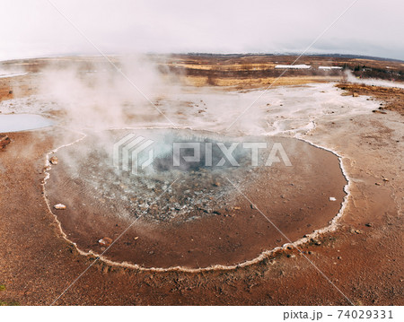 Geyser Valley in the southwest of Iceland. The famous tourist attraction Geysir. Geothermal zone Haukadalur. Strokkur geyser on the slopes of Laugarfjall hill. Geyser Valley in the southwest of Iceland. The famous tourist attraction Geysir. Geothermal zone Haukadalur. Strokkur geyser on the slopes of Laugarfjall hill. 74029331