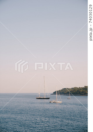 Three sailing yachts moored near the island of Lokrum in Croatia, Dubrovnik. Three sailing yachts moored near the island of Lokrum in Croatia, Dubrovnik. 74030129