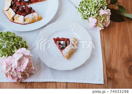 Delicious freshly baked vegan strawberry and cherry galette. 74033298