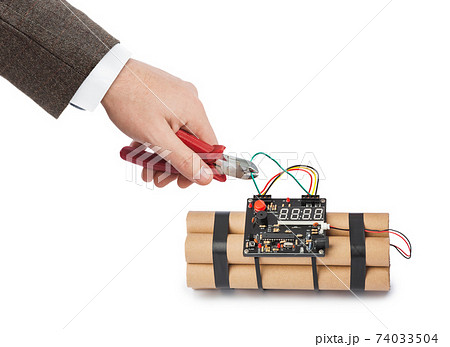 Hand with pliers and dynamite bomb 74033504