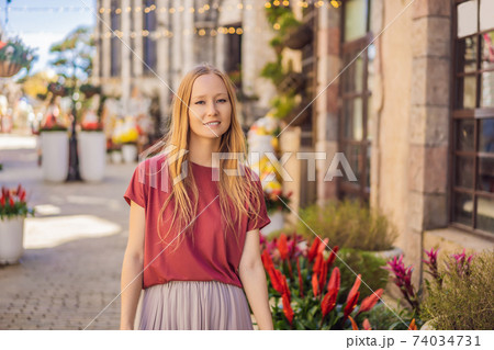 Young woman tourist walks down the street in a European city after the end of COVID-19 coronavirus. quarantine is over Young woman tourist walks down the street in a European city after the end of COVID-19 coronavirus. quarantine is over 74034731