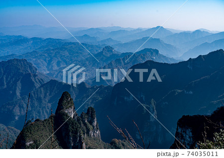 Dreamy mountain ranges landscape with misty sky in China 74035011