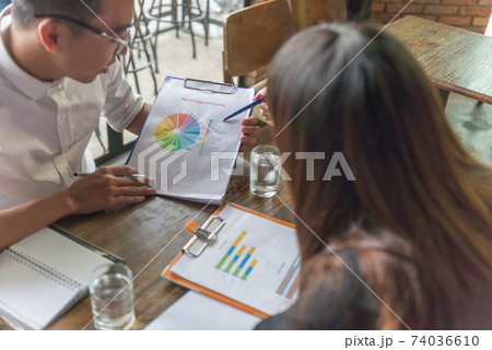 Business team discuss about financial report document 74036610