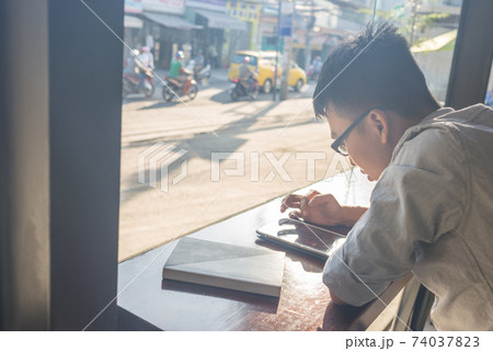 Asian young student using tablet 74037823