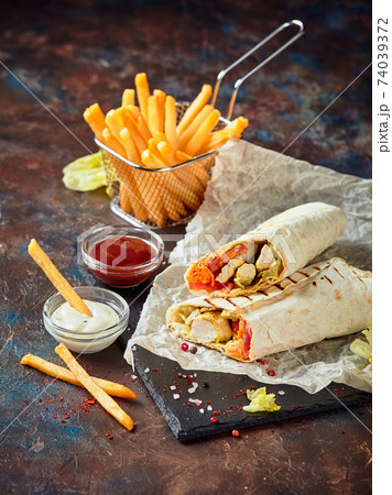 Eastern traditional shawarma, and French fries with sauces on slate 74039372