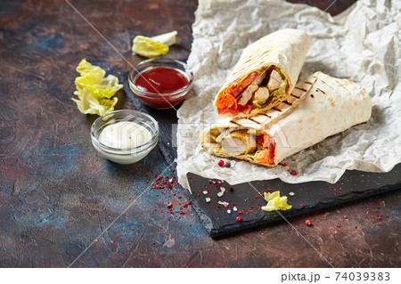 Eastern traditional shawarma with sauces Eastern traditional shawarma with sauces 74039383