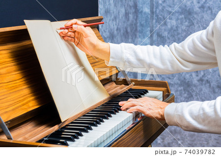 male professional songwriter playing piano while writing a hit song. songwriting concept 74039782