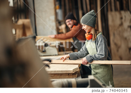 Craftswoman working with wood in workshop Craftswoman working with wood in workshop 74040345