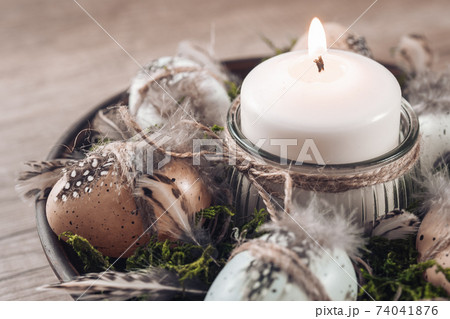 Spring decor ideas Diy. How to make Easter floral arrangement with decorative eggs, candle and moss. 74041876