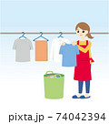 洗濯物を干すエプロンの女性 74042394