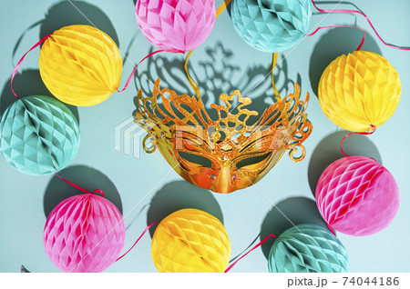 Carnival mask and confetti on a blue background. The concept of a traditional venetian carnival in 74044186