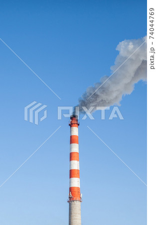 White thick smoke from the boiler room chimney. Industrial zone. 74044769