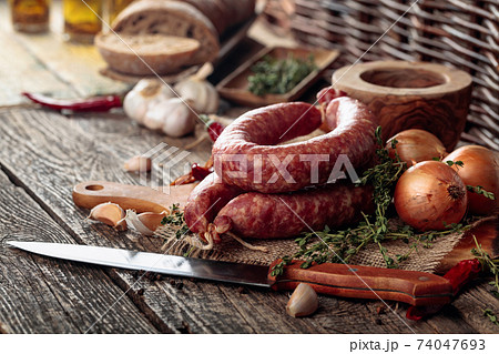 Sausage with bread and spices on a old wooden table. 74047693