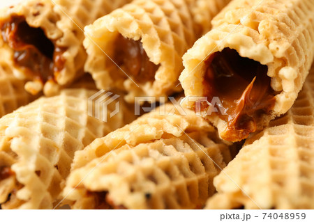 Tasty wafer rolls with condensed milk, close up Tasty wafer rolls with condensed milk, close up 74048959