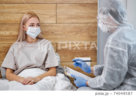 unknown man-doctor and patient discussing current health examination while sitting at home 74049587
