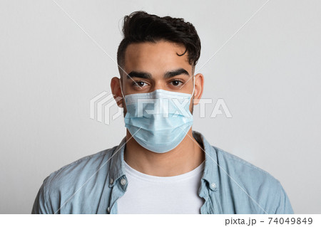 Closeup Portrait Of Young Arab Man In Protective Medical Mask On Face Closeup Portrait Of Young Arab Man In Protective Medical Mask On Face 74049849