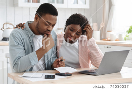 Stressed Black Couple Calculating Family Budget In Kitchen, Suffering Financial Crisis 74050037