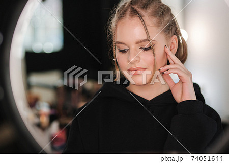 Attractive young woman with nude makeup posint for photo. Portrait of pretty blond hair woman in beauty studio 74051644