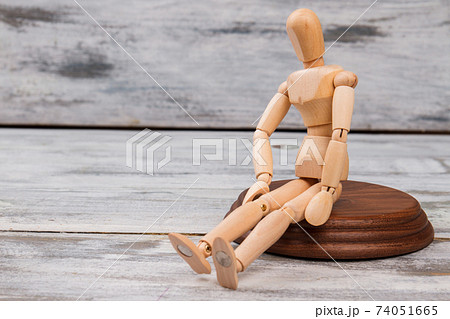 Sitting mannequin on wood. 74051665