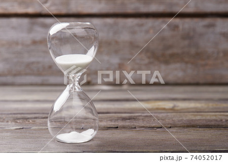 Hourglass with white sand close up. Hourglass with white sand close up. 74052017