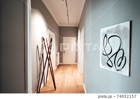 a corridor in an apartment with a painting on the wall a corridor in an apartment with a painting on the wall 74052157