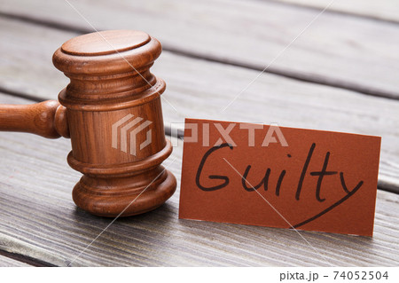 Wooden hammer and guilty word. Wooden hammer and guilty word. 74052504