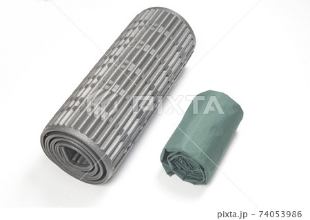 rolled up polyurethane mat and folded air mattress for camping and tourism  74053986