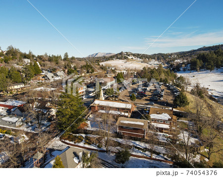 Aerial view of historic Downtown City of Julian during snow day. 74054376