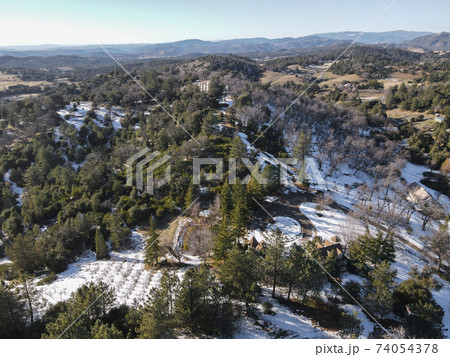 Aerial view of historic Downtown City of Julian during snow day. 74054378