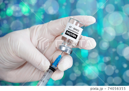 Coronavirus Covid-19 Vaccine. Doctor filling syringe injection with vaccine Coronavirus Covid-19 Vaccine. Doctor filling syringe injection with vaccine 74056355