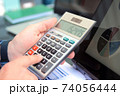 Businessman / accountant is doing calculations. Tax season. 74056444